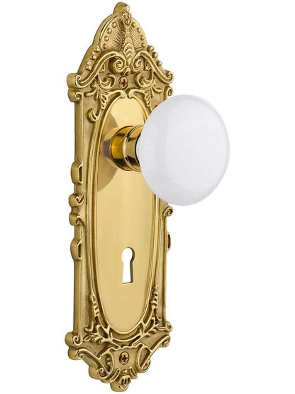 Largo Door Set with White Porcelain Knobs and Keyhole in Un-Lacquered Brass.